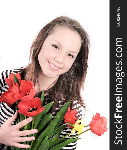 A nice girl with red tulips isolated on white background