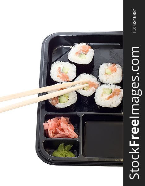 Rolls of sushi on a plate with chopsticks.