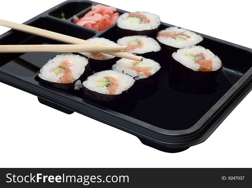 Rolls of sushi on a plate with chopsticks.