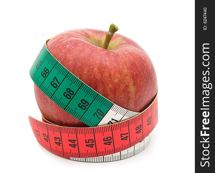 Red apple in measuring tape on white background