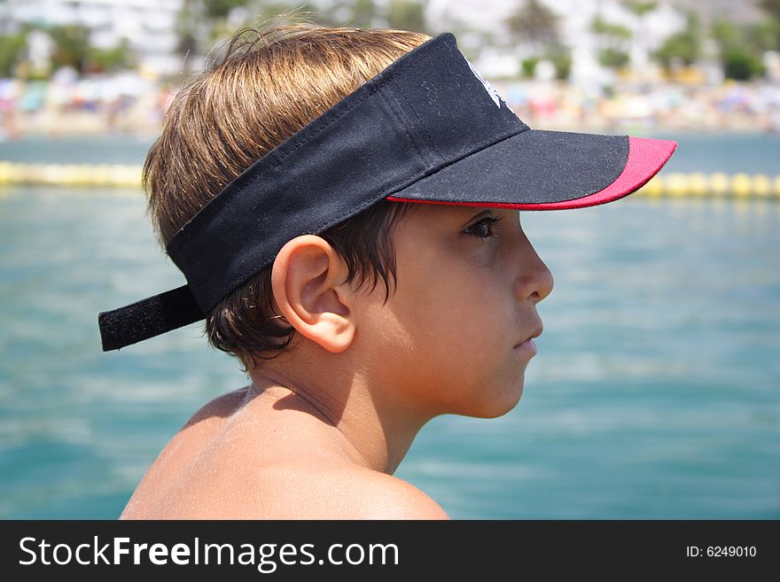 Child in the beach looking with a serious face. Child in the beach looking with a serious face