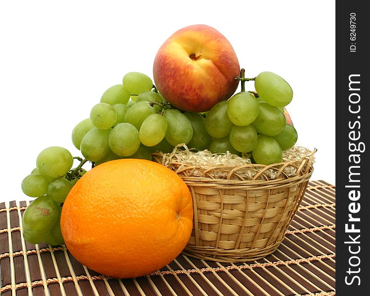 Useful and ripe fruit in a basket on a striped napkin. Useful and ripe fruit in a basket on a striped napkin