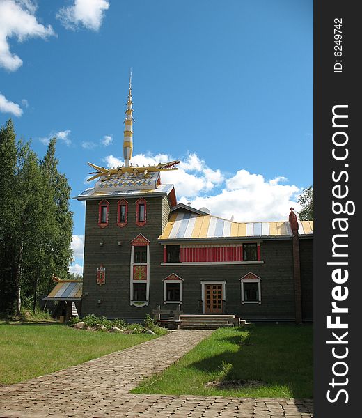 Russian style. Wooden blockhouse on the blue sky background. Russian style. Wooden blockhouse on the blue sky background.