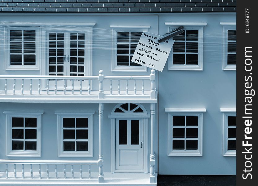 Conceptual image of model house for sale - reflecting the down turn of the housing market. Conceptual image of model house for sale - reflecting the down turn of the housing market