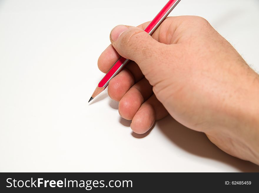Men's right hand holding a pencil on over white