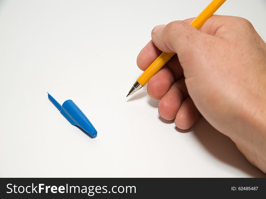 Men's right hand holding a pen on over white