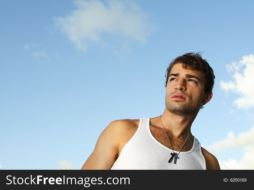 Young man watching the sunset with blue sky background. Young man watching the sunset with blue sky background.