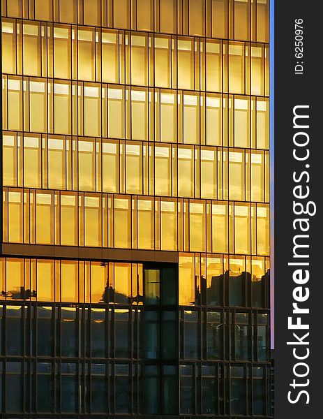 Windows on office building at sunset (vertical version). Windows on office building at sunset (vertical version)