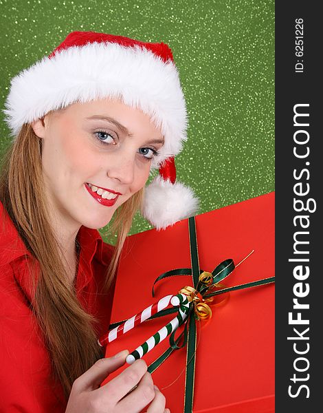 Christmas girl holding a red gift box with decorations. Christmas girl holding a red gift box with decorations