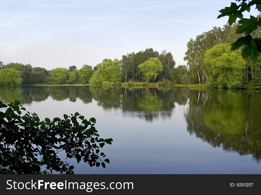 Big pond in town outside forest . Summer time. Big pond in town outside forest . Summer time.