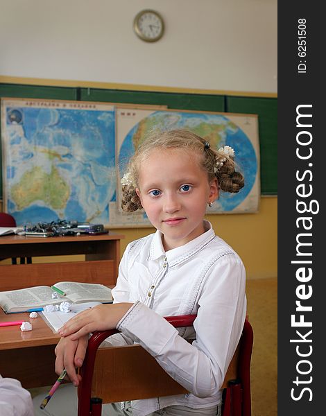 The beautiful girl with blue eyes at a geography lesson. The beautiful girl with blue eyes at a geography lesson.