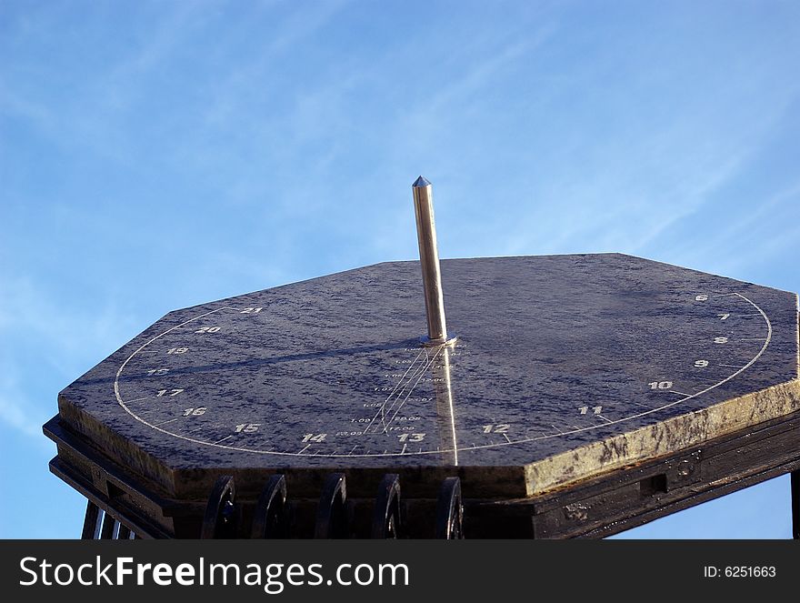 Marble sundial against the pure blue sky