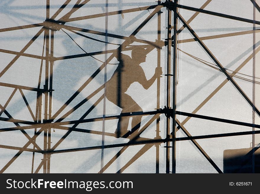 Silhouette of worker at construction frame