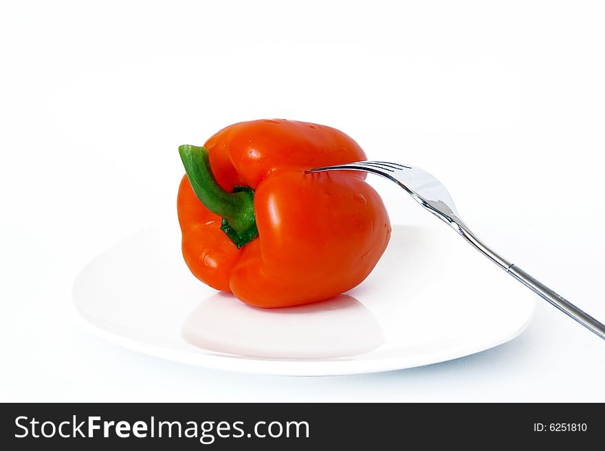 Sweet pepper and fork on a white plate. Sweet pepper and fork on a white plate