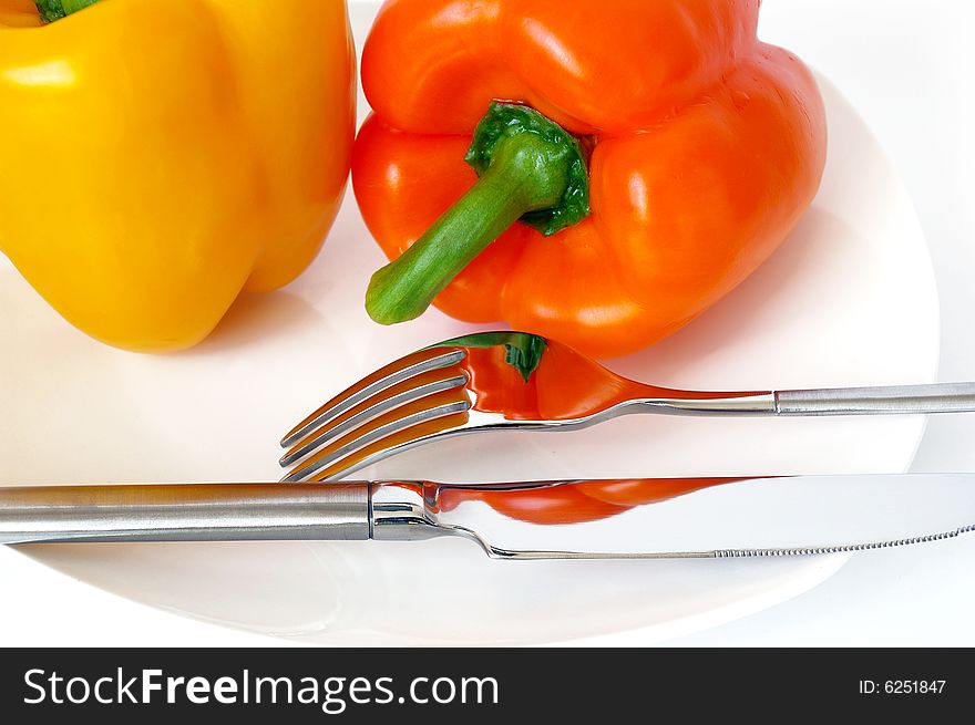 Sweet pepper and fork on a white plate. Sweet pepper and fork on a white plate