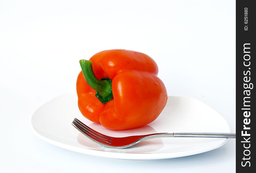 Sweet pepper and fork on a white plate. Sweet pepper and fork on a white plate