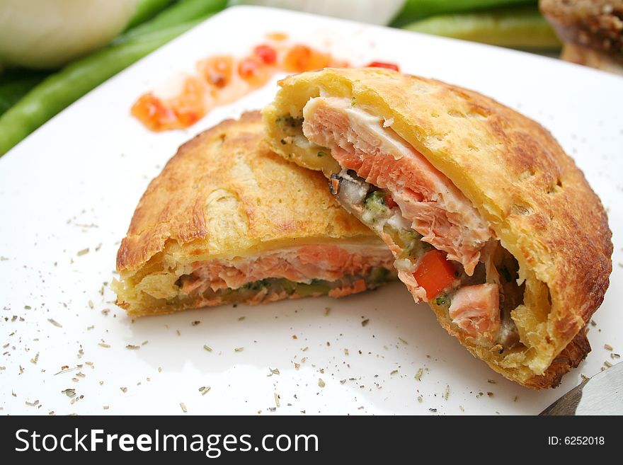 Fresh salmon fish in bread on a plate