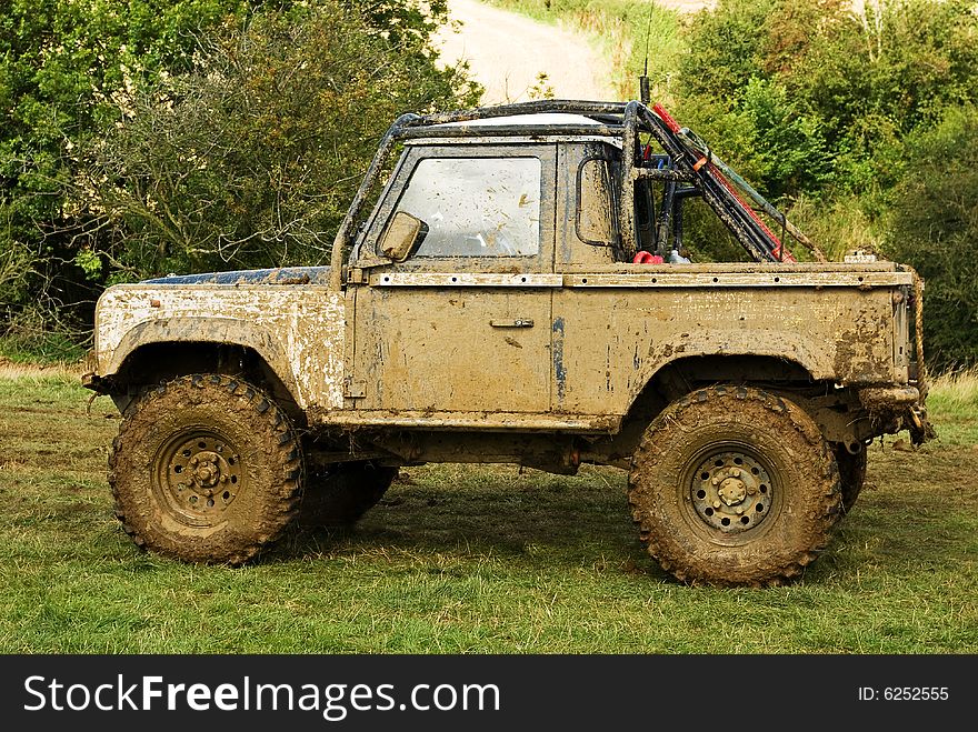 An off road vehicle is in need of a wash. An off road vehicle is in need of a wash