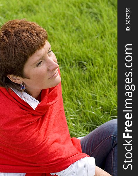 Closeup portrait of woman sitting on the grass