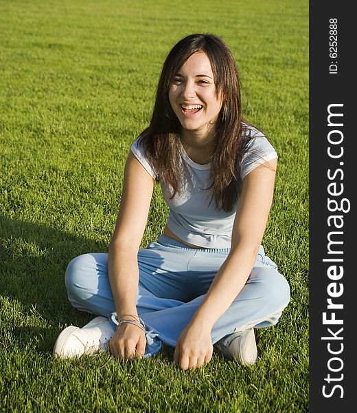 Girl laughing in the middle of a football court. Girl laughing in the middle of a football court.