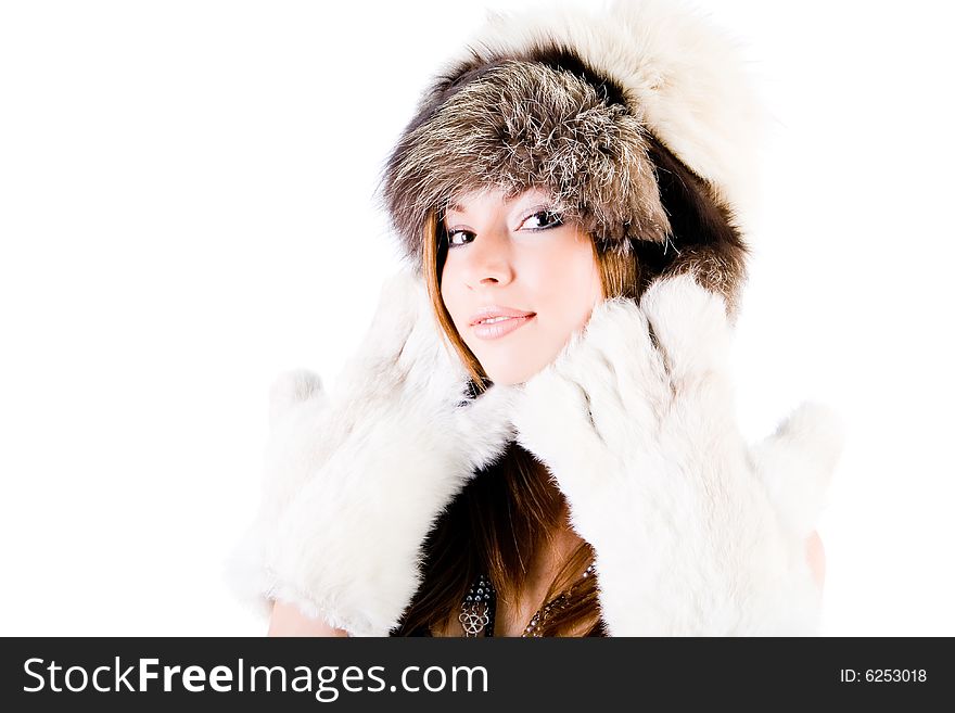 Close-up portrait  of the young girl in fur-cap on white background. Close-up portrait  of the young girl in fur-cap on white background