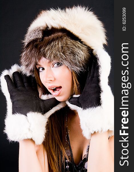 Close-up portrait of the girl in fur-cap and gloves. Close-up portrait of the girl in fur-cap and gloves