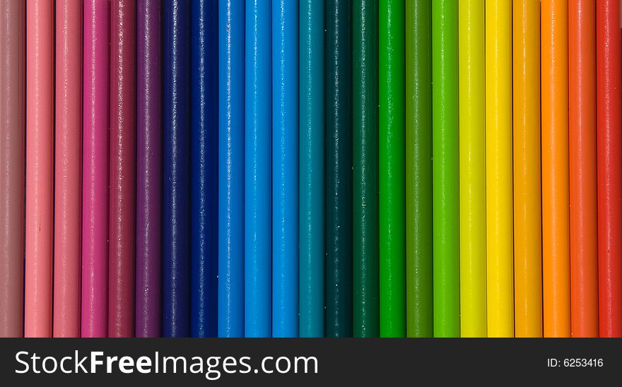 Rows of brightly colored pencils in a horizontal rainbow pattern facing right while isolated on a white background. Rows of brightly colored pencils in a horizontal rainbow pattern facing right while isolated on a white background