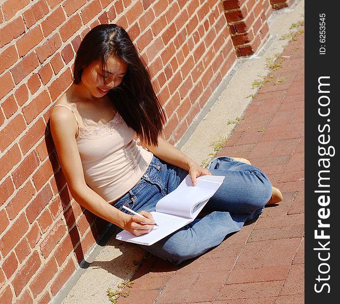 Girl Writing In Note Book