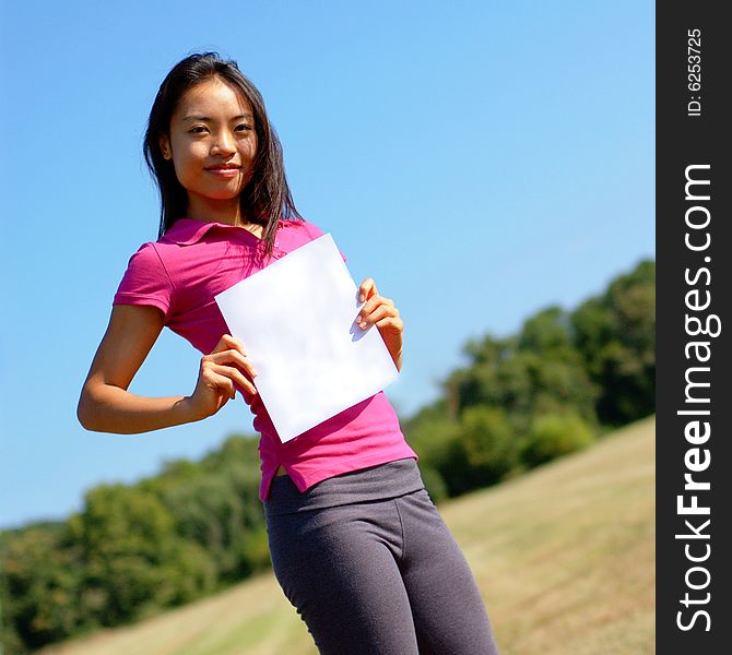 Girl with blank sign in field