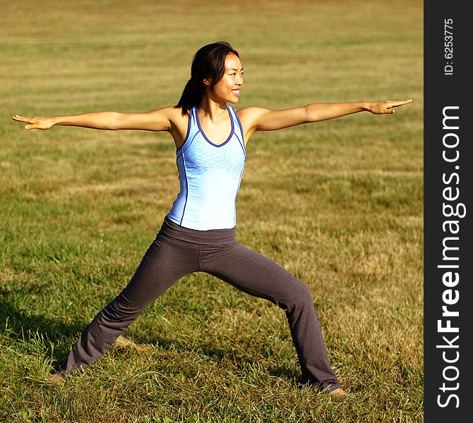 Girl practicing yoga in a summer meadow. Girl practicing yoga in a summer meadow.