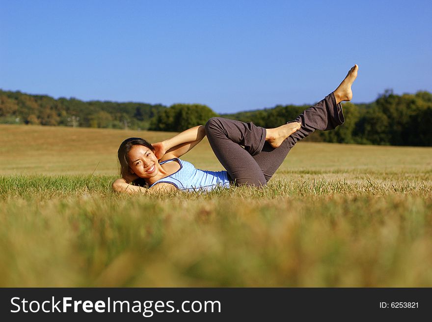 Girl Practicing Yoga In Field