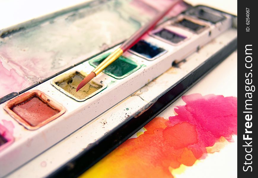 Close-up of watercolor paint with paint brush