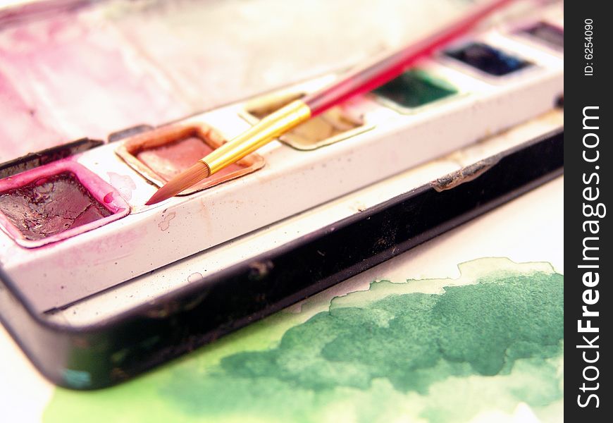 Close-up of watercolor paint with paint brush