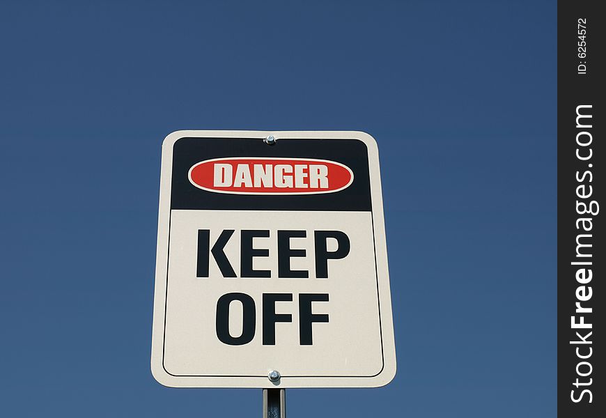 A sign saying Danger Keep Off on a clear day.