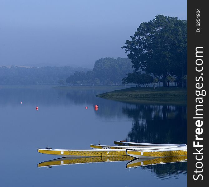 Yellow sporting boats in a lake/reservior in the morning in Singapore. Yellow sporting boats in a lake/reservior in the morning in Singapore.