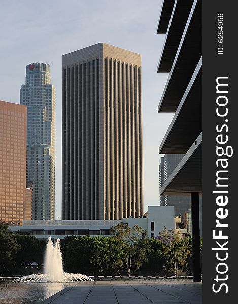 Tall skyscrapers tower above a plaza with fountains in downtown Los Angeles. Tall skyscrapers tower above a plaza with fountains in downtown Los Angeles