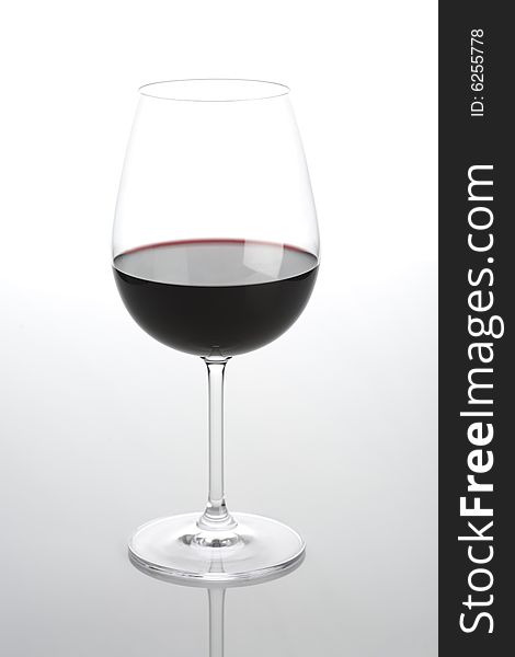 Glass of wine isolated on a light background. Glass of wine isolated on a light background