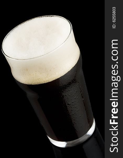 Dark beer isolated on a black background