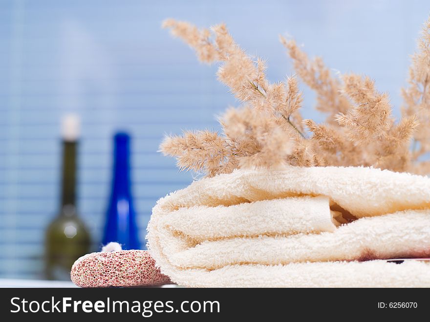 Bath background with towel, sponge and bottles