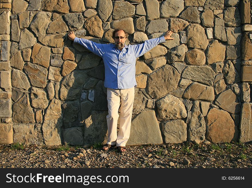 Adult man leaning against the wall. Adult man leaning against the wall
