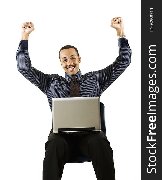 A young professional African-American male working on a laptop. A young professional African-American male working on a laptop.