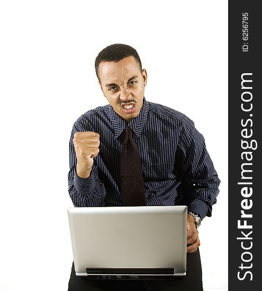 A young professional African-American male working on a laptop. A young professional African-American male working on a laptop.