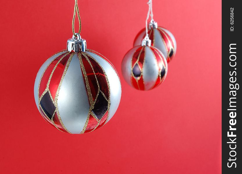 Decorations for the Christmas tree brightly lit on red background. Decorations for the Christmas tree brightly lit on red background