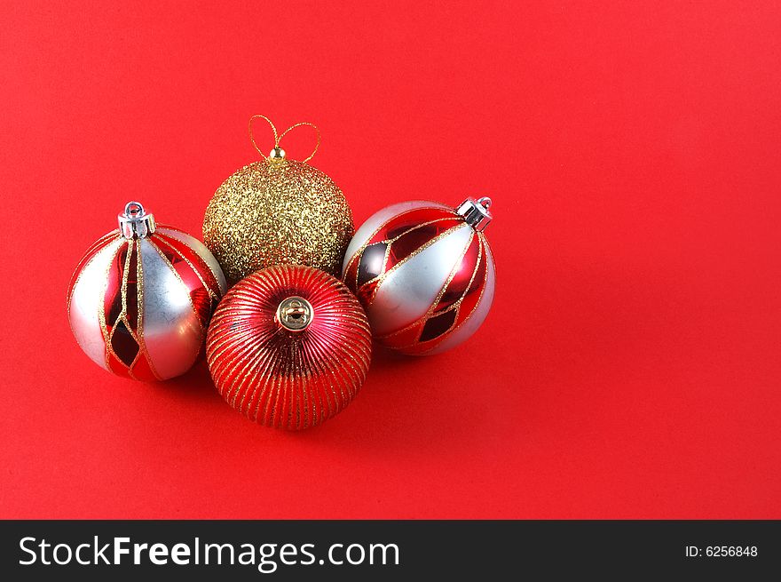 Decorations for the Christmas tree brightly lit on red background. Decorations for the Christmas tree brightly lit on red background