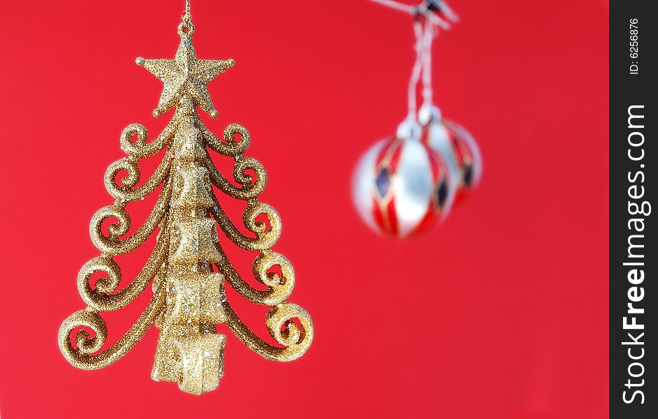 Decorations for the Christmas tree brightly lit on red background. Decorations for the Christmas tree brightly lit on red background