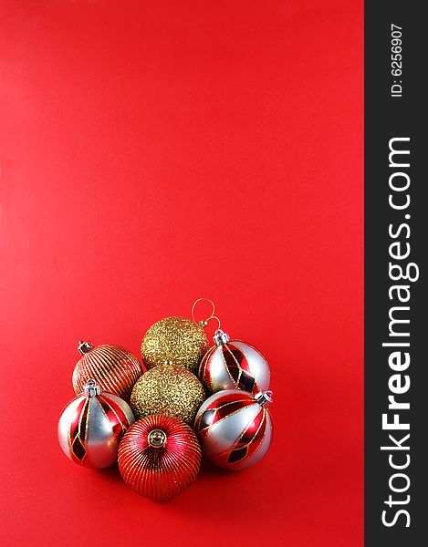 Decorations for the Christmas tree brightly lit on red background. Decorations for the Christmas tree brightly lit on red background