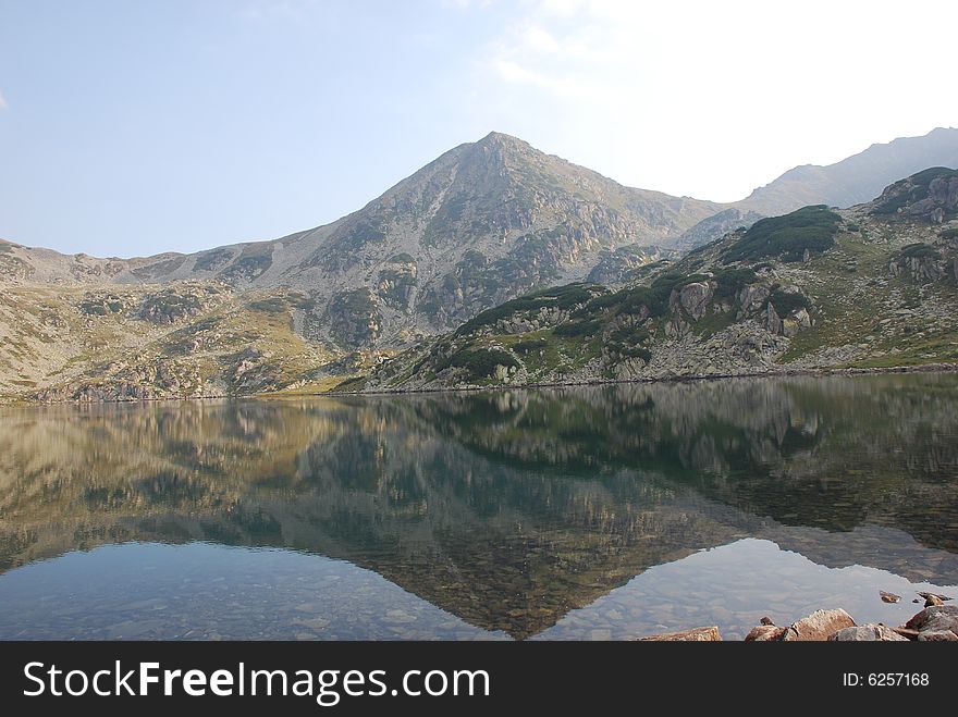 Landscape with mountains reflected in the lake. Landscape with mountains reflected in the lake