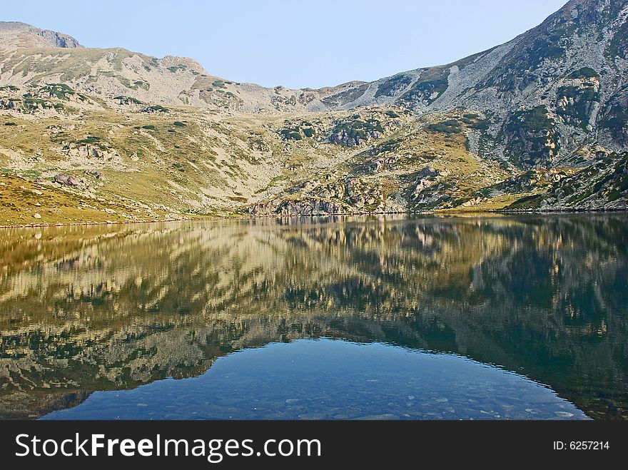 Landscape with mountains reflected in the lake. Landscape with mountains reflected in the lake