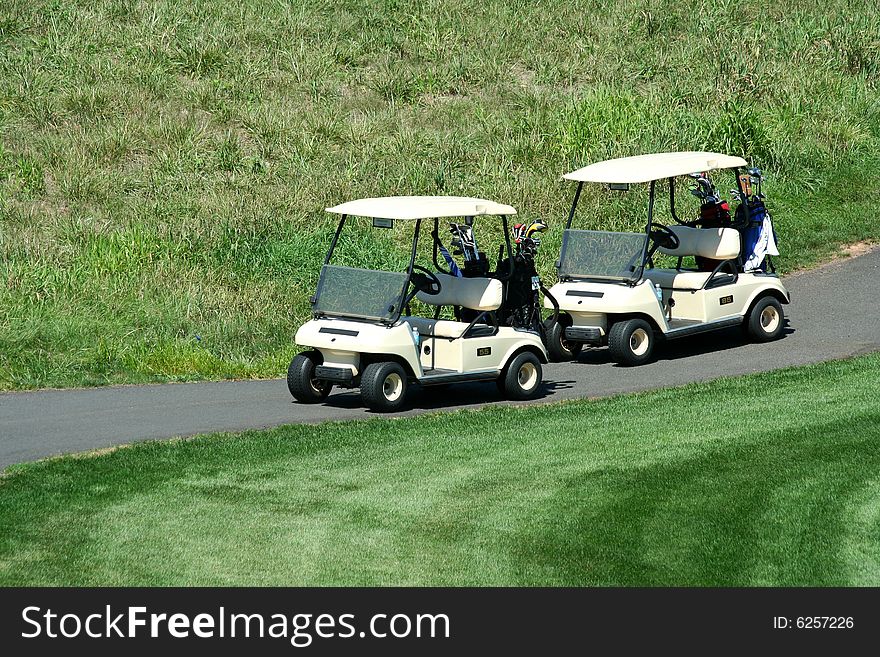 Two golf carts on the cart path