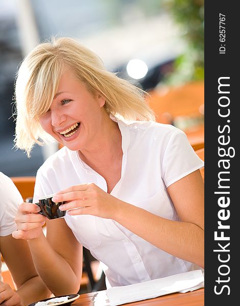 Lovely young girl with cup of coffee